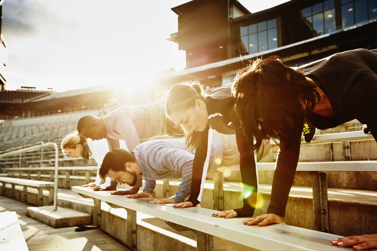 Participants mirroring torso positions with skyline backdrop